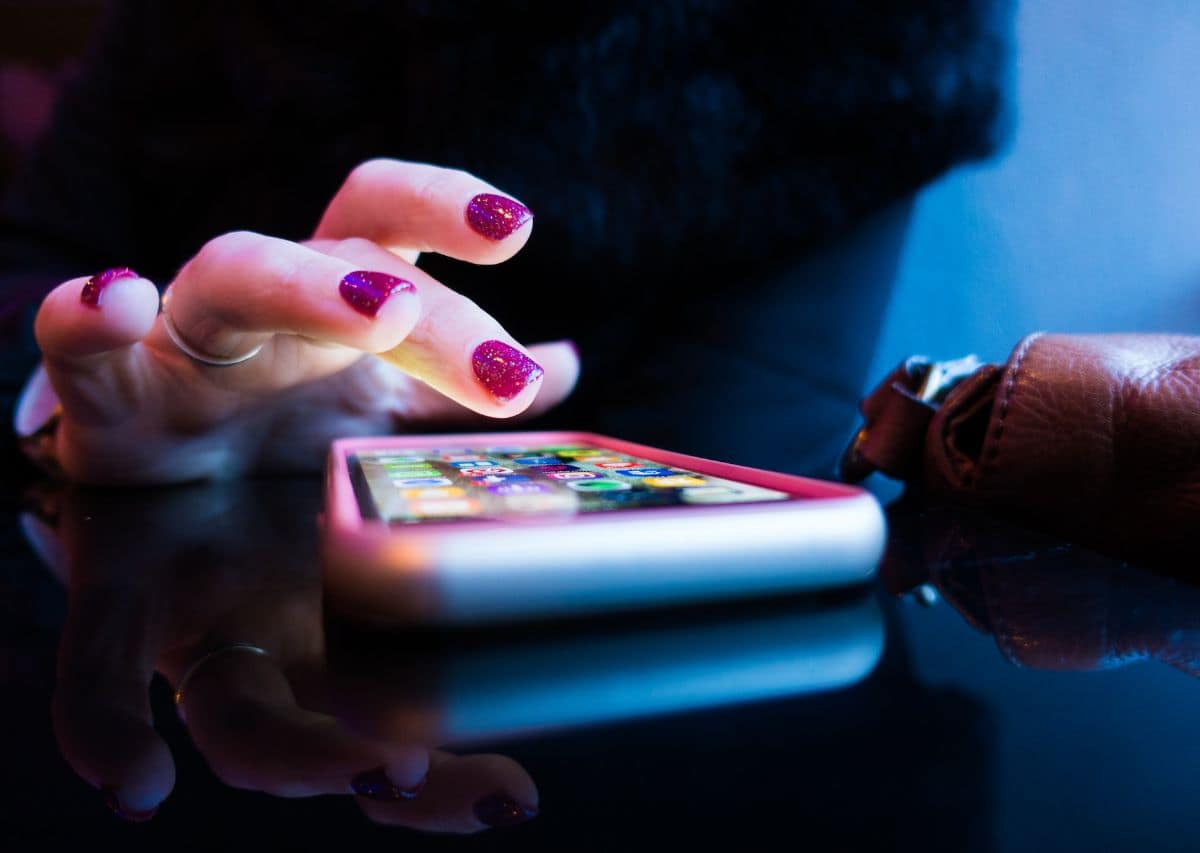 Woman mesmerized by social media on her phone