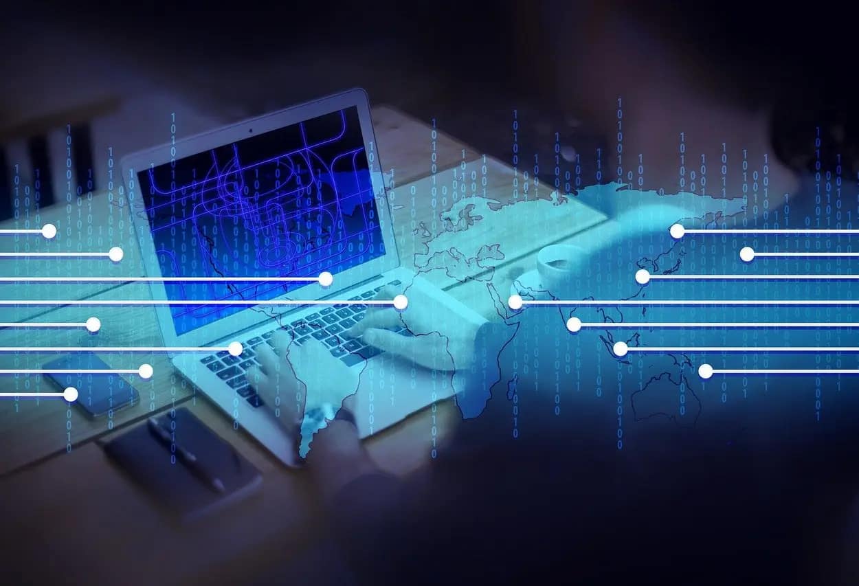 Digital concept of a laptop with global network overlay, representing the global reach of a website after migration.
