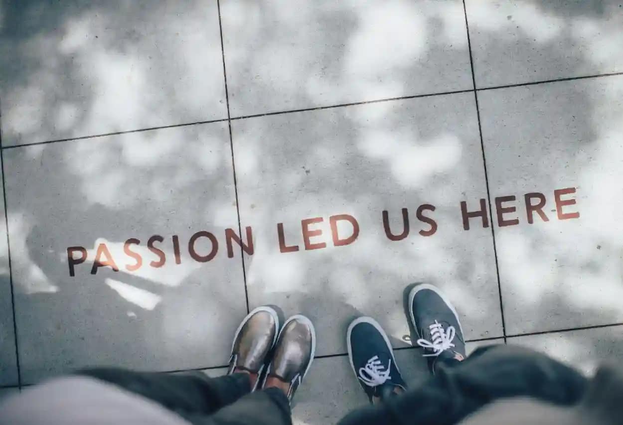 Ground shadow text 'Passion led us here' representing commitment to changing the world