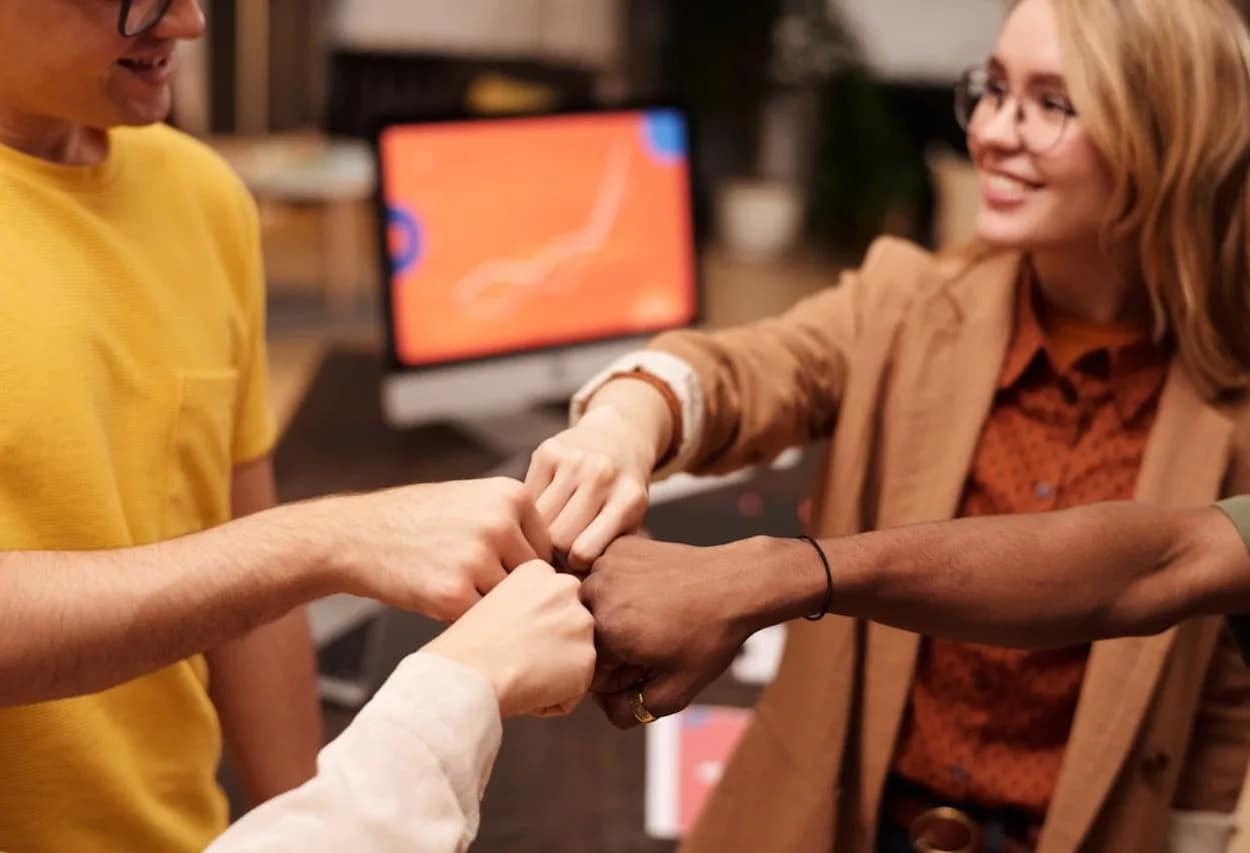Teamwork in digital agency celebrating the success of their SEO joint efforts