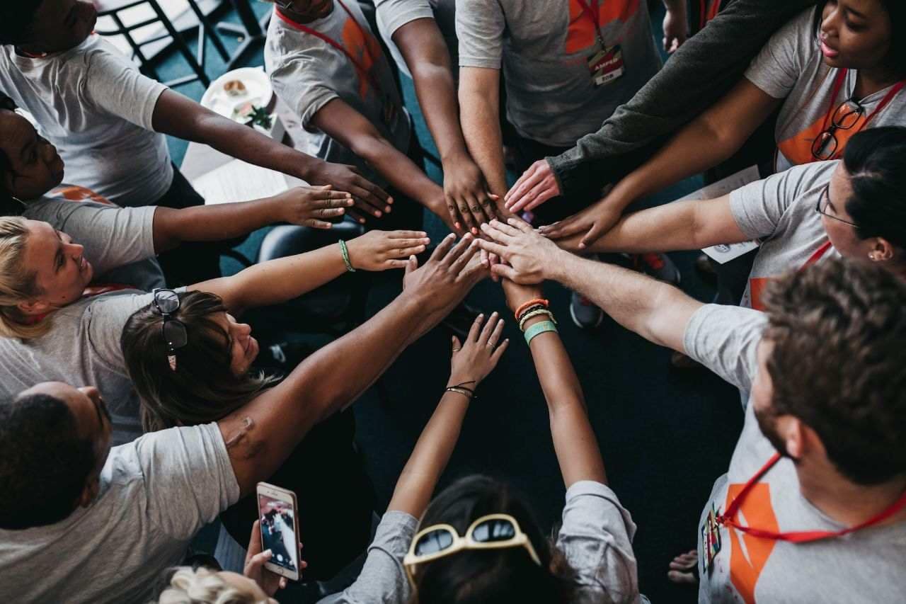 NGO Volunteers joining hands and celebrating SEO project success