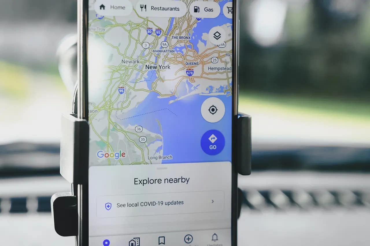 In-car navigation showing local map on smartphone, representing the power of local SEO for driving small business discoverability.
