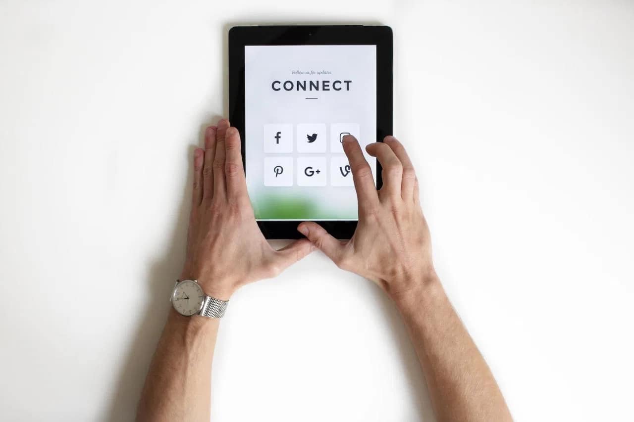 Digital marketer engaging in content optimization through social media platforms on a tablet