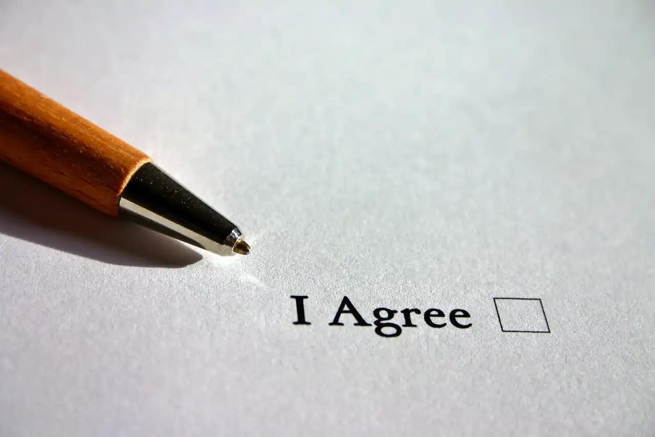 Commitment to sustainable marketing practices represented by a pen poised to agree on eco-friendly policies and compliances.