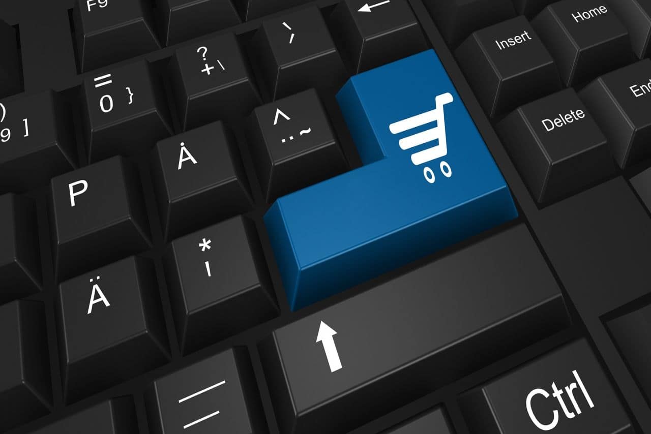 Conceptual image of a blue shopping cart icon on a keyboard key, symbolizing the importance of SEO in boosting e-commerce sales.