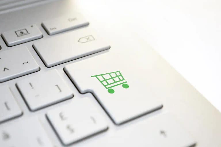 Close-up of a shopping cart icon on a computer keyboard key, symbolizing online shopping optimization in a CRO checklist.