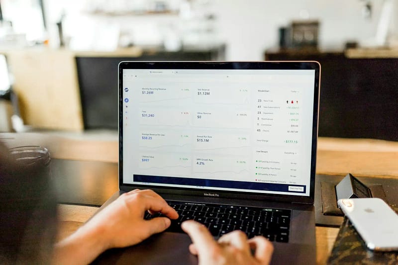 CRO expert analyzing real-time revenue data on a laptop to optimize conversion strategies.