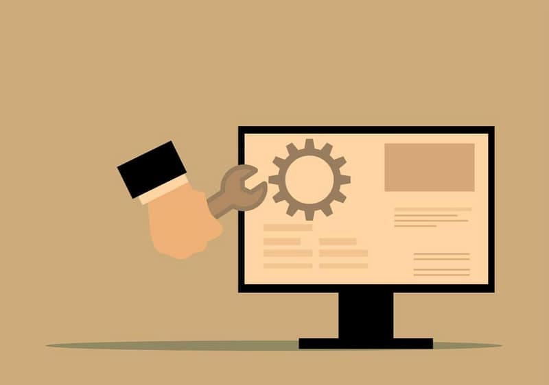 Graphic of a hand fixing a website with a wrench